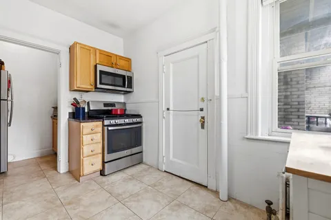 a kitchen with stainless steel appliances granite countertop a refrigerator and a stove