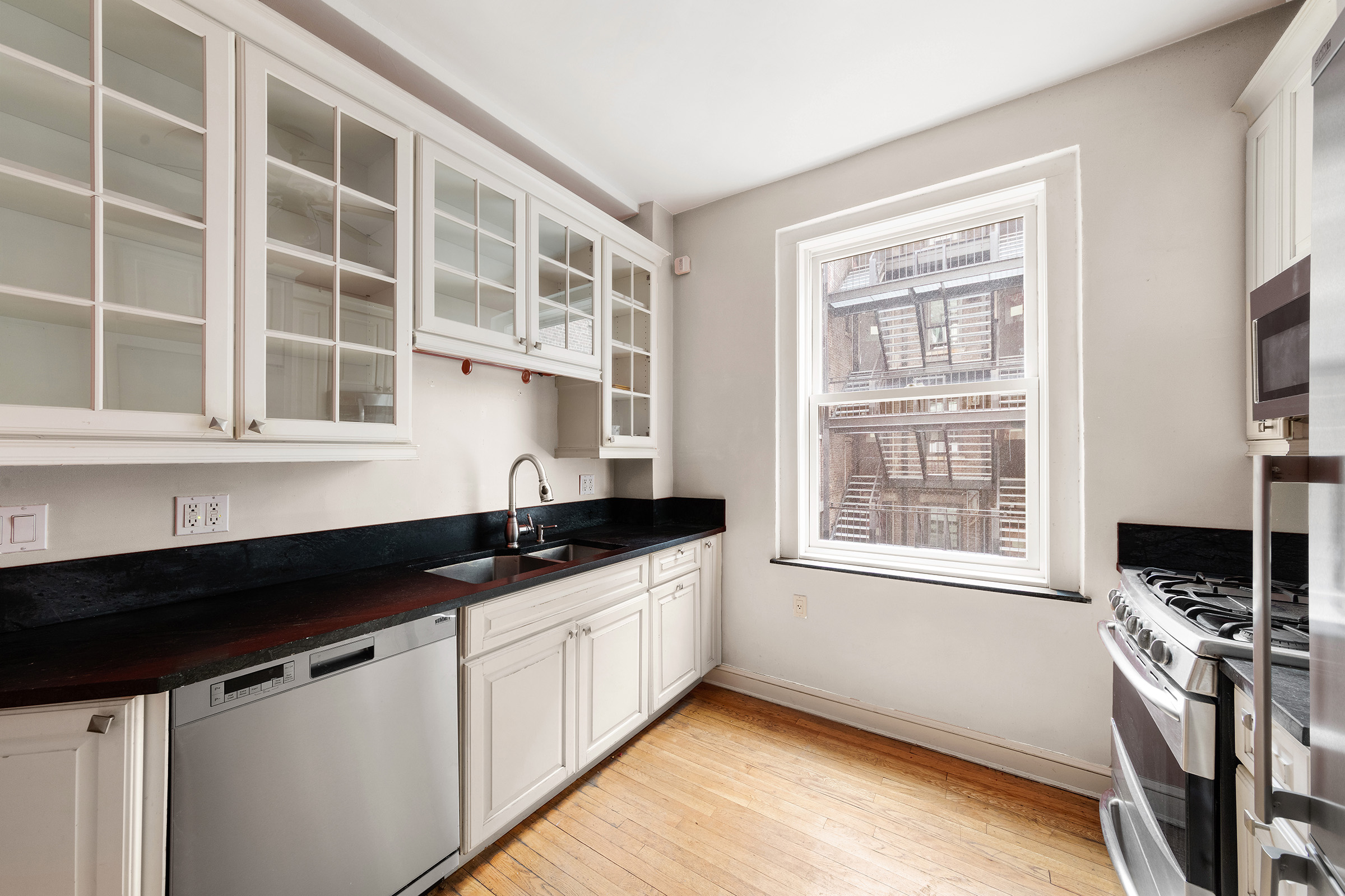 360 Riverside Drive, Unit 8A Manhattan, NY 10025 - Photo 9 of 20 a kitchen with granite countertop a stove and a sink