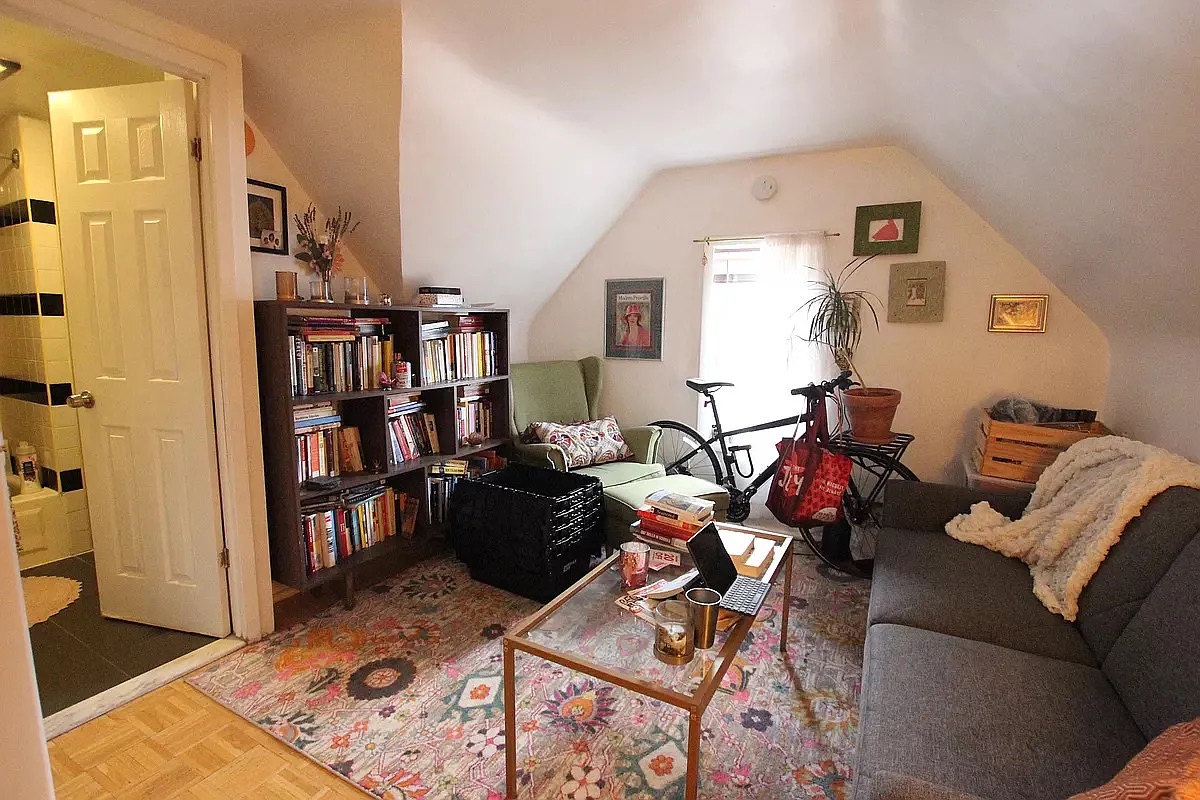 258 East 5th Street, Unit 4 Brooklyn, NY 11218 - Photo 2 of 5 a living room with furniture and a book shelf