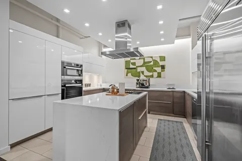 a kitchen with cabinets and stainless steel appliances