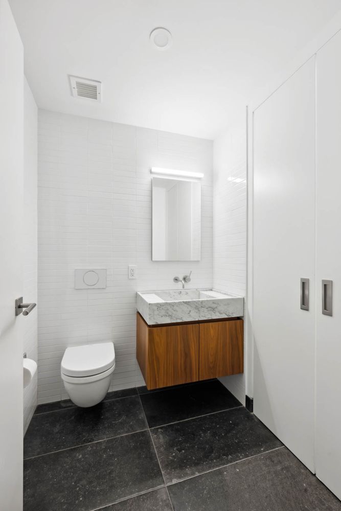 a bathroom with a sink toilet a mirror and vanity