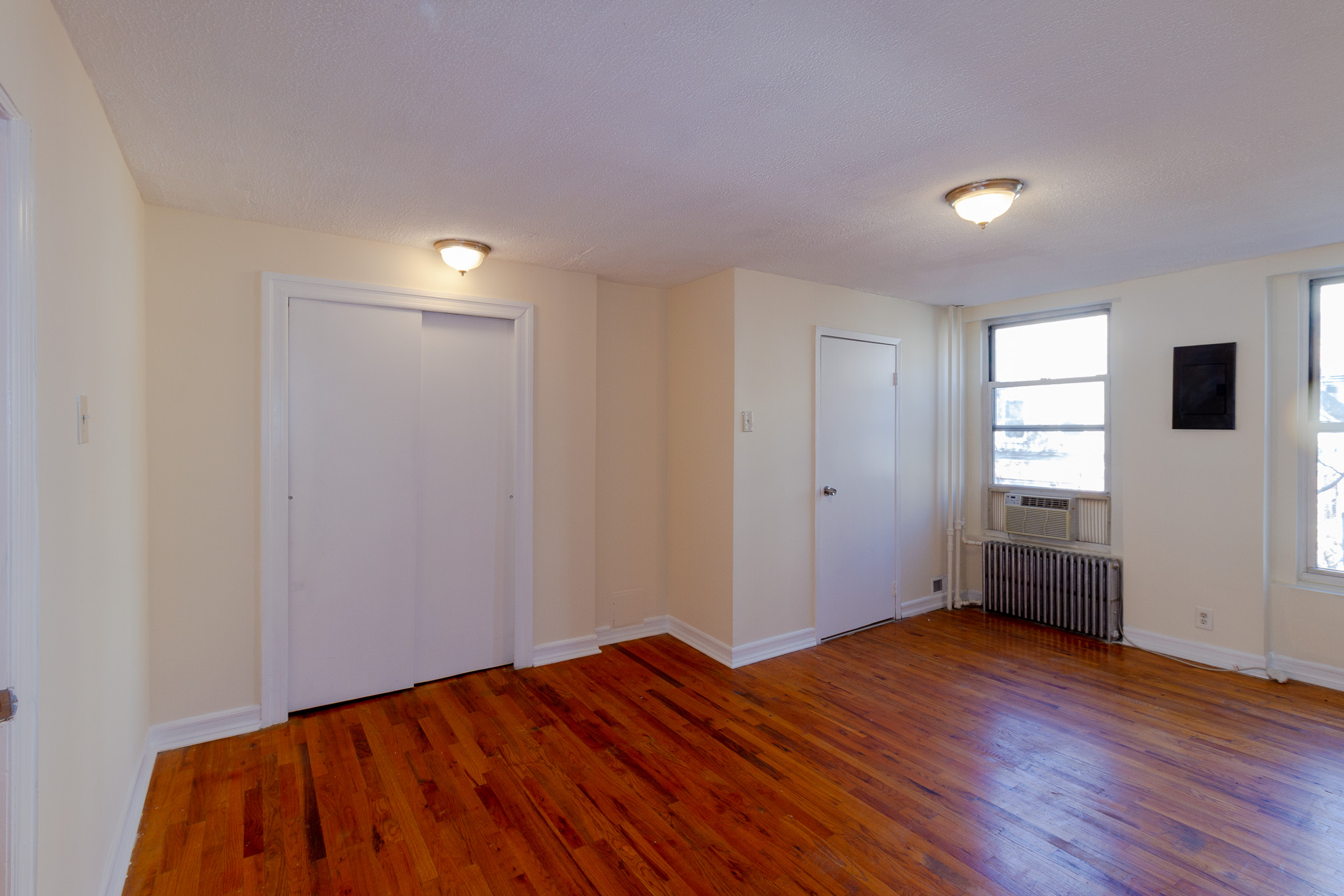 145 Atlantic Avenue, Unit 2 Brooklyn, NY 11201 - Photo 9 of 11 a view of empty room with wooden floor and fan