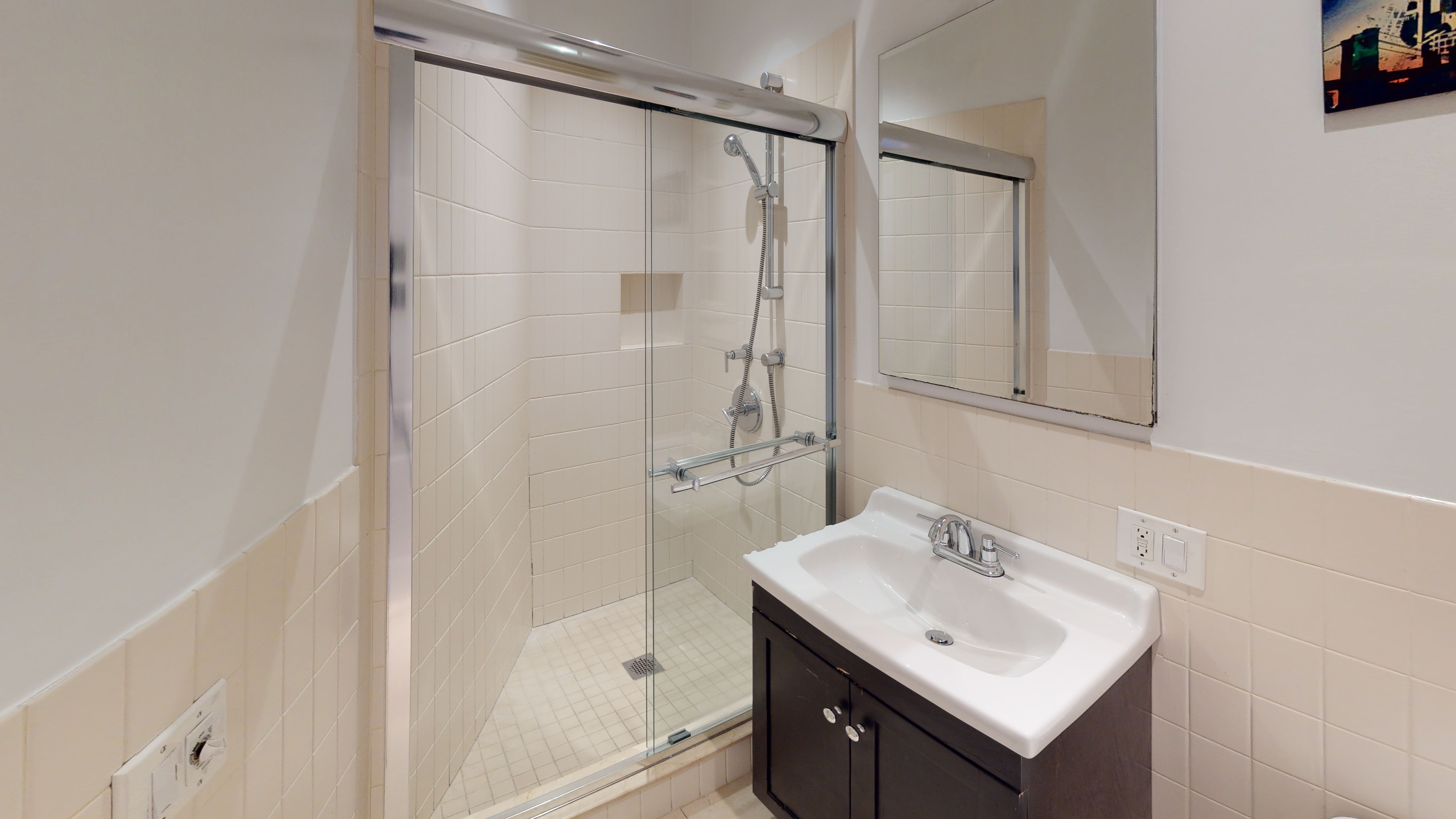 332 15th Street, Unit 3 Brooklyn, NY 11215 - Photo 7 of 8 a bathroom with a sink mirror and shower