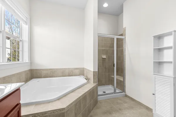 a bathroom with a tub and shower