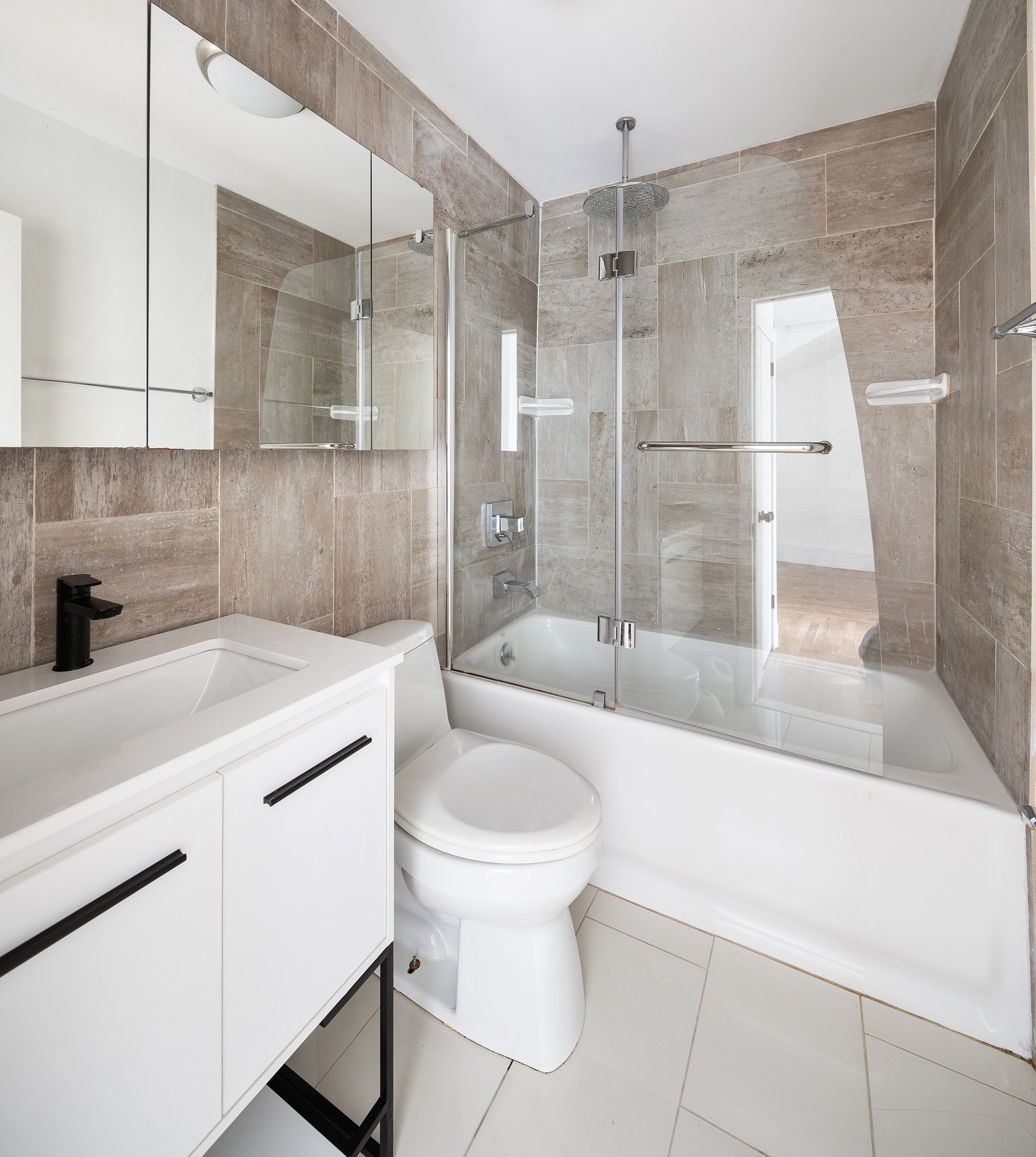 306 Gates Avenue, Unit 1A Brooklyn, NY 11216 - Photo 11 of 14 a bathroom with a sink toilet and shower