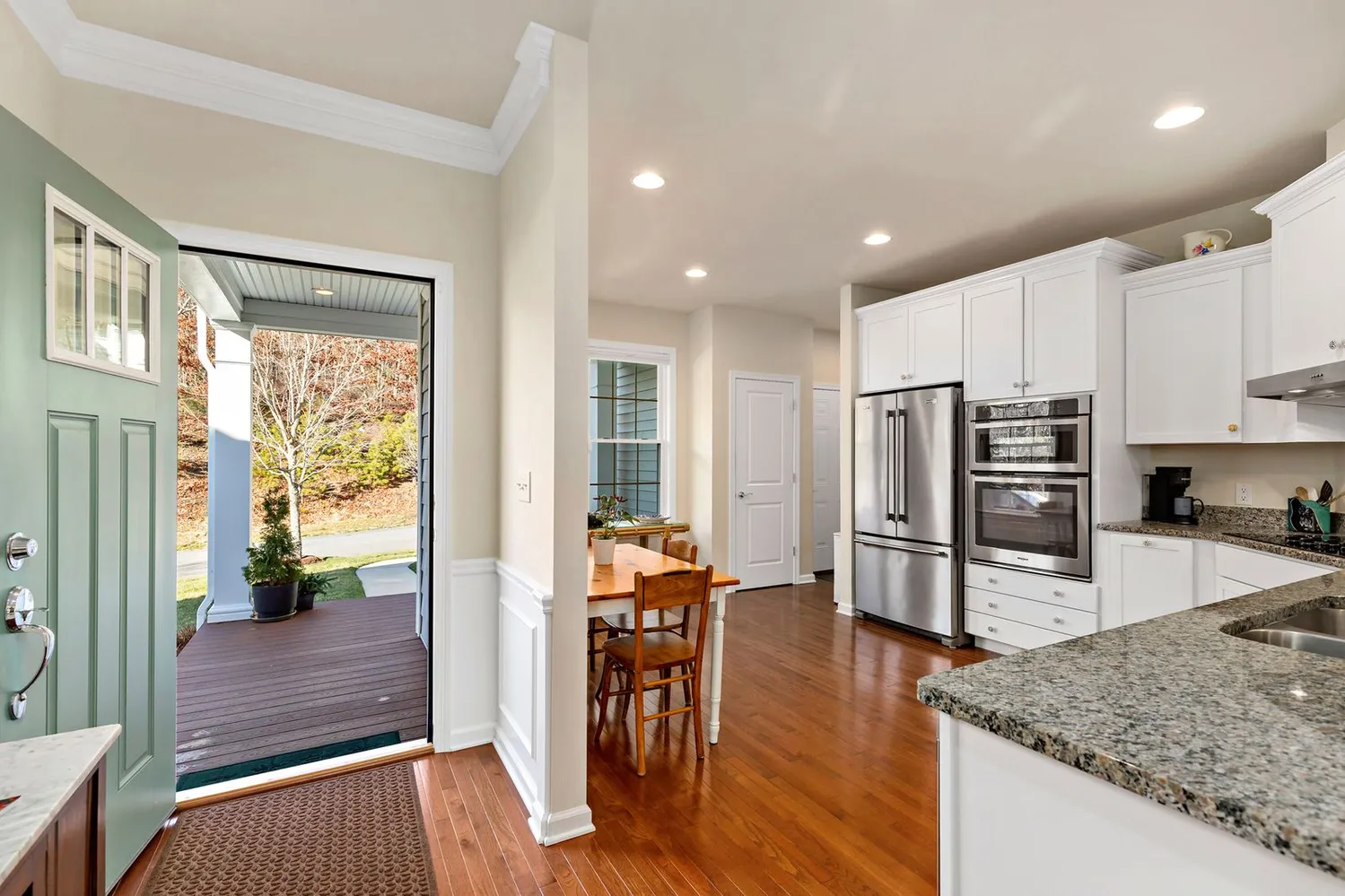 a kitchen with stainless steel appliances granite countertop a refrigerator and a stove top oven