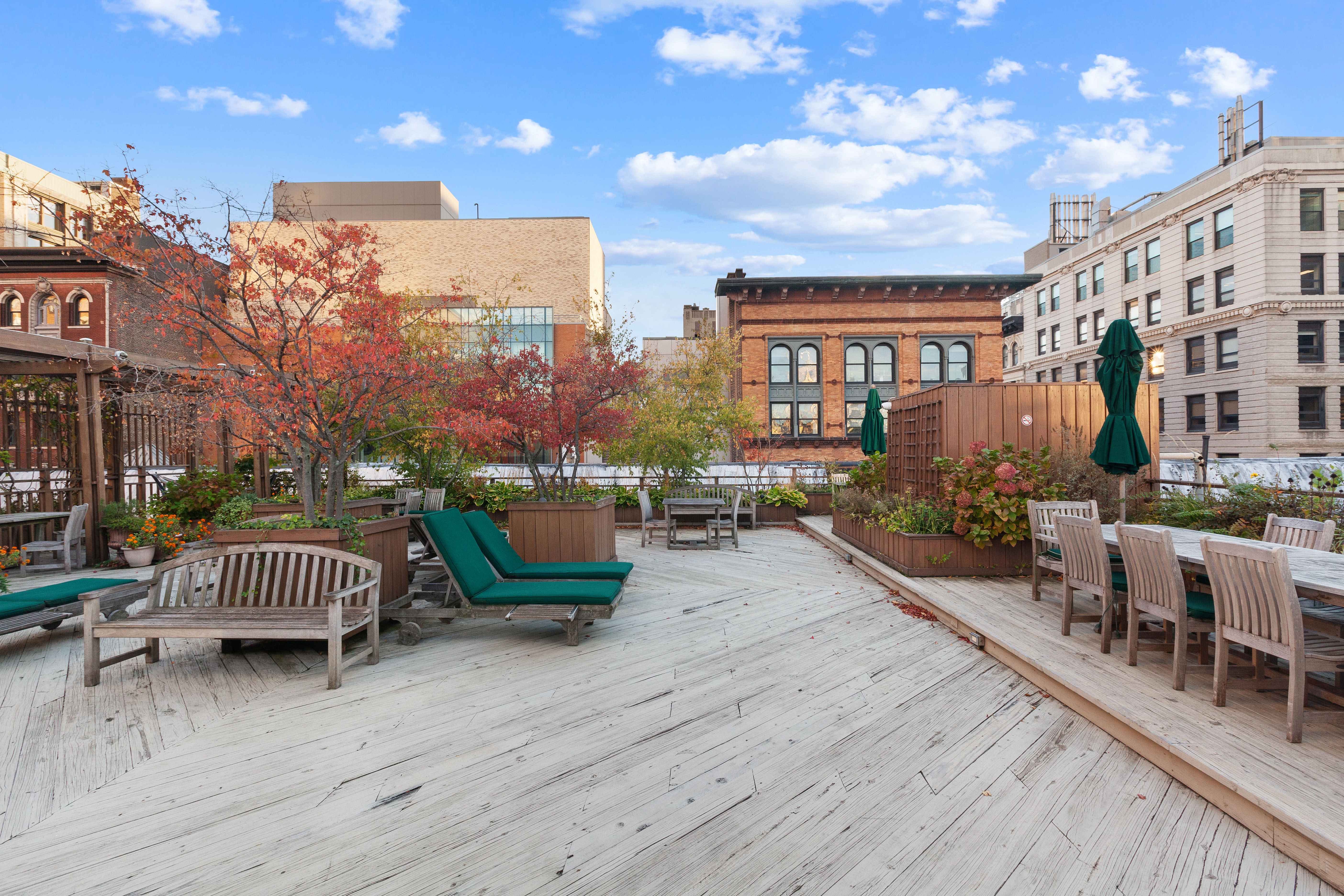 23 Waverly Place, Unit 2P Manhattan, NY 10003 - Photo 6 of 7 a view of a patio with couches and table and chairs with wooden floor and fence