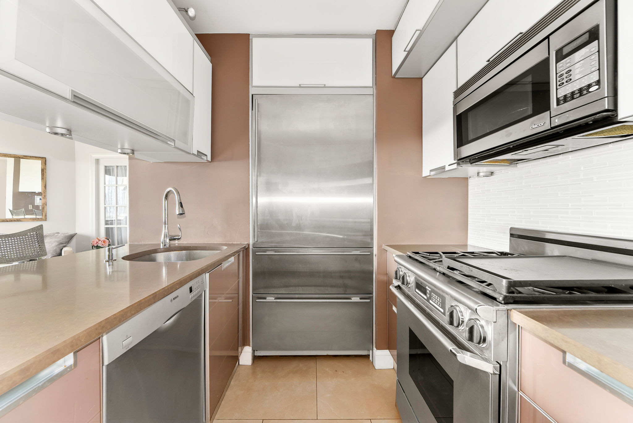 415 East 37th Street, Unit 9D Manhattan, NY 10016 - Photo 3 of 6 a kitchen with stainless steel appliances granite countertop a sink and a stove