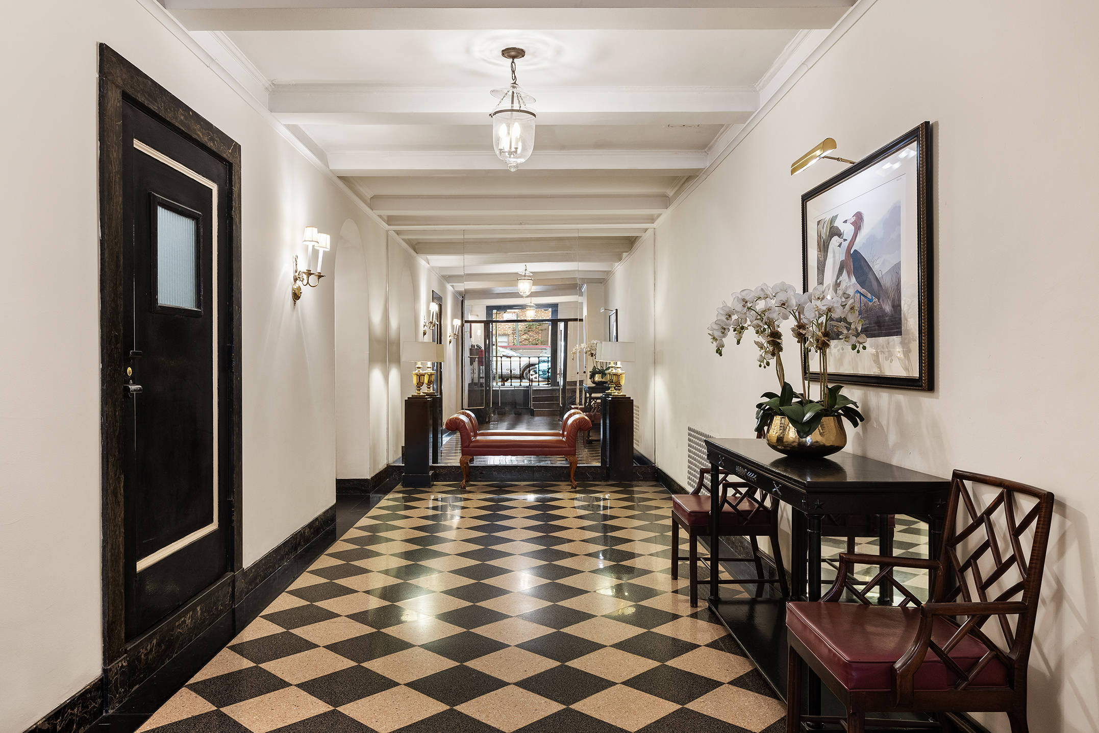 81 Irving Place, Unit 15DE Manhattan, NY 10003 - Photo 14 of 18 a dining room with chandelier and wooden floor
