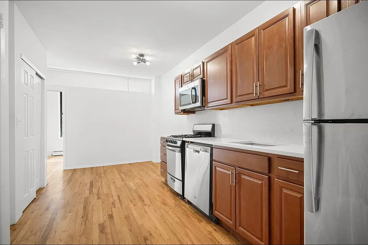 103 West 105th Street, Unit 5A Manhattan, NY 10025 - Photo 2 of 11 a kitchen with stainless steel appliances granite countertop a refrigerator and a stove top oven