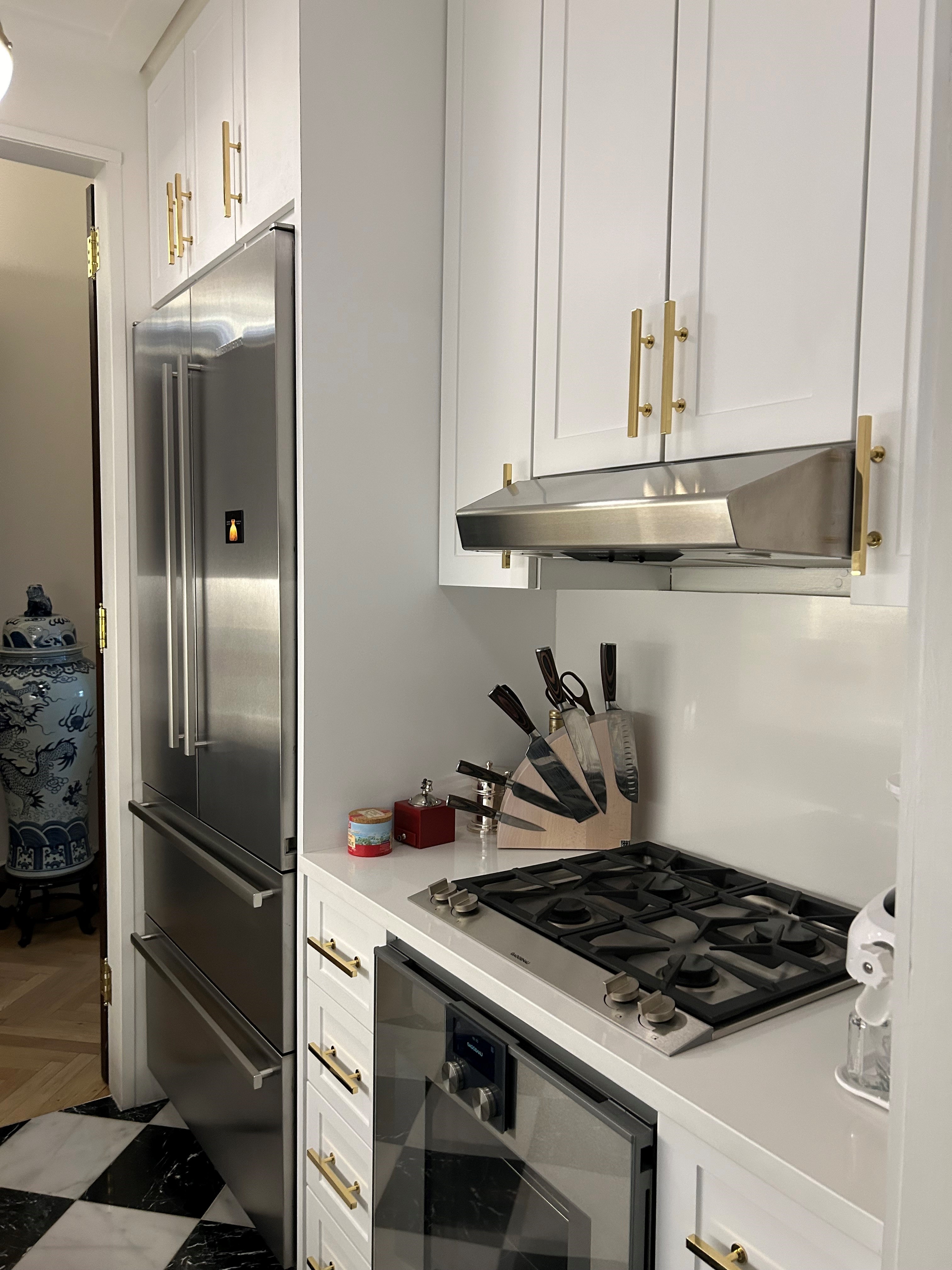 36 East 69th Street, Unit 2AB Manhattan, NY 10021 - Photo 17 of 26 a kitchen with stainless steel appliances granite countertop a refrigerator and a sink