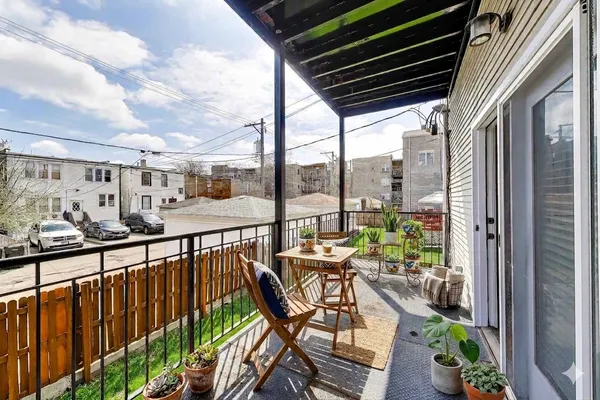 a view of a chairs and table in patio with wooden fence