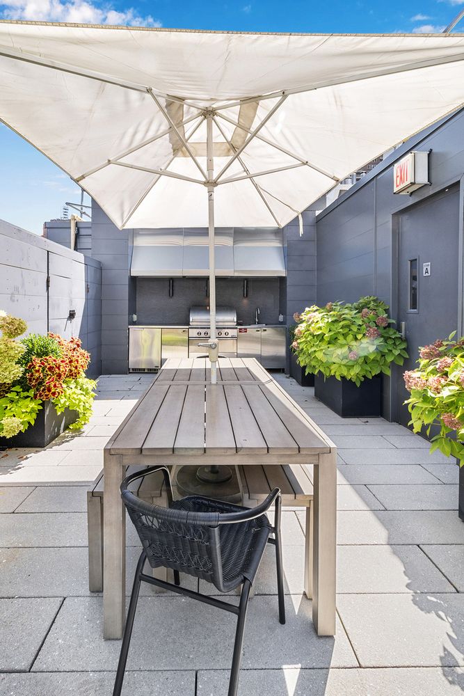 a view of a patio with table and chairs potted plants