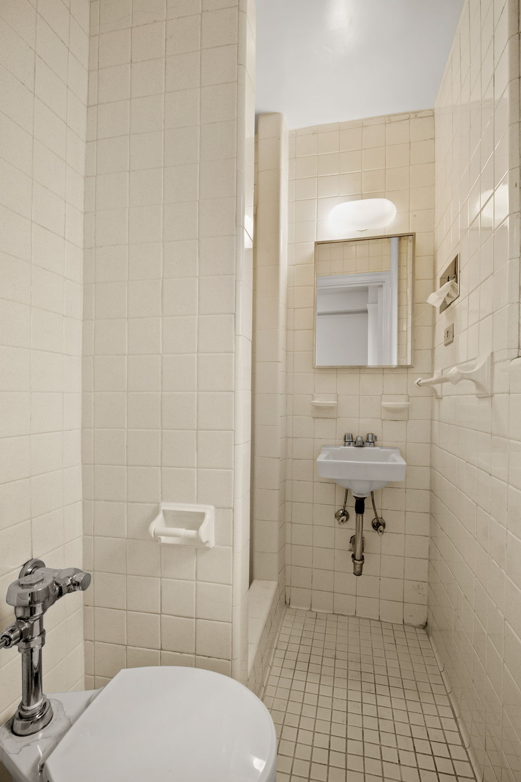 235 West End Avenue, Unit 12H Manhattan, NY 10023 - Photo 12 of 16 a bathroom with a sink toilet and shower