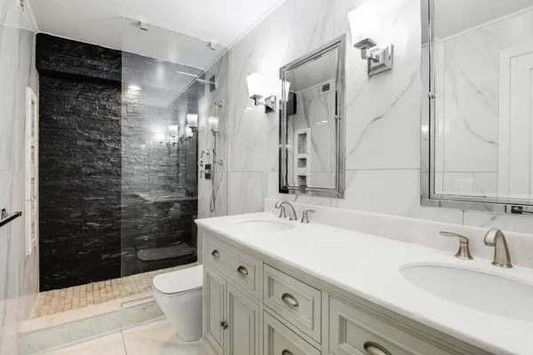 a bathroom with a sink a toilet and shower