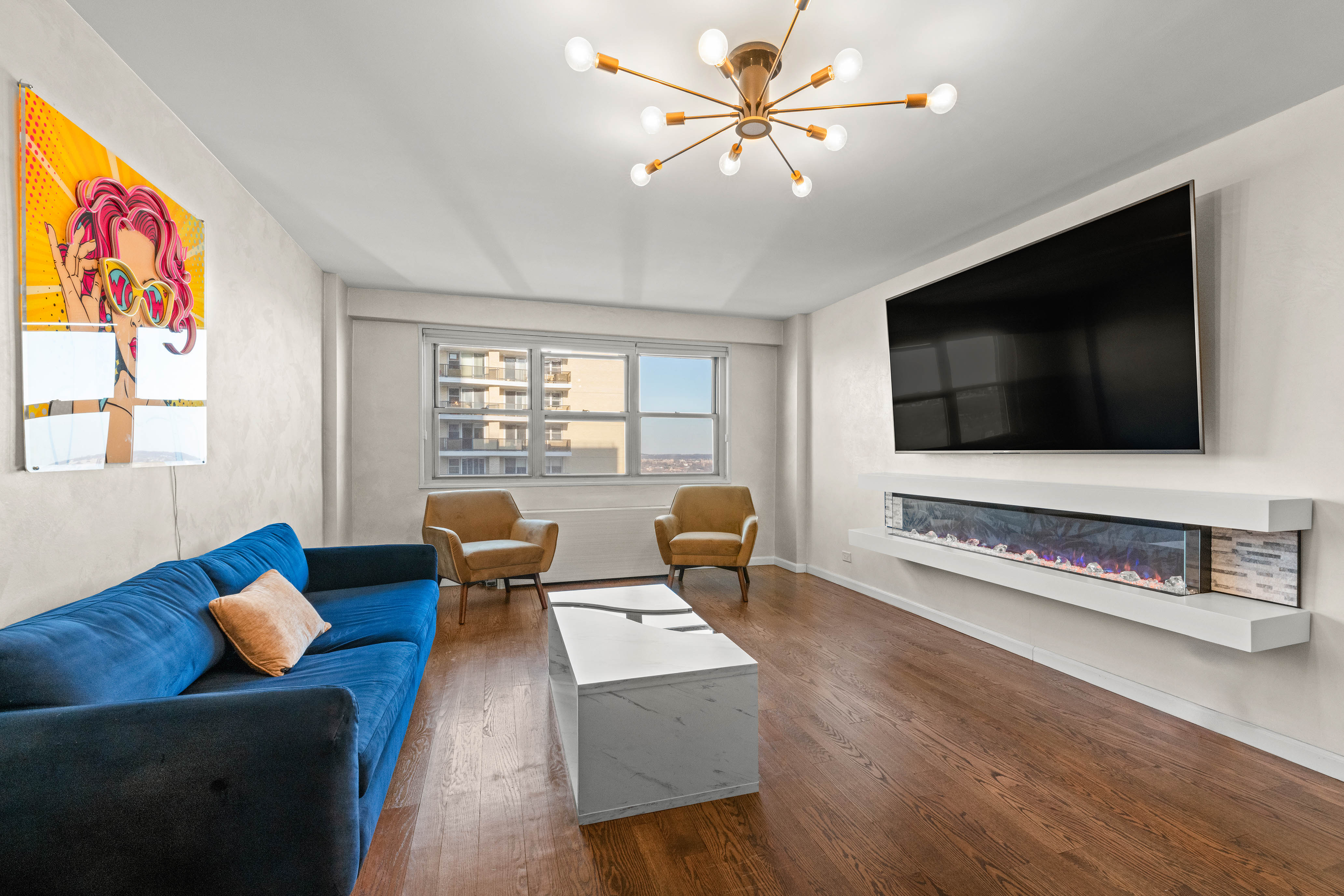 102-10 66th Road, Unit K25 Queens, NY 11375 - Photo 2 of 19 a living room with furniture and a flat screen tv