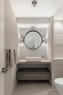 a bathroom with a toilet a sink and a mirror
