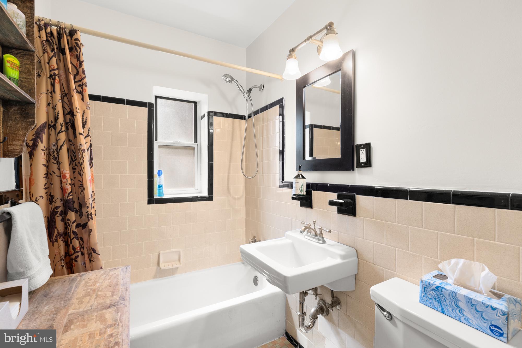 4100 W Street Northwest, Unit 314 Washington, DC 20007 - Photo 21 of 28 a bathroom with a sink mirror and a bathtub