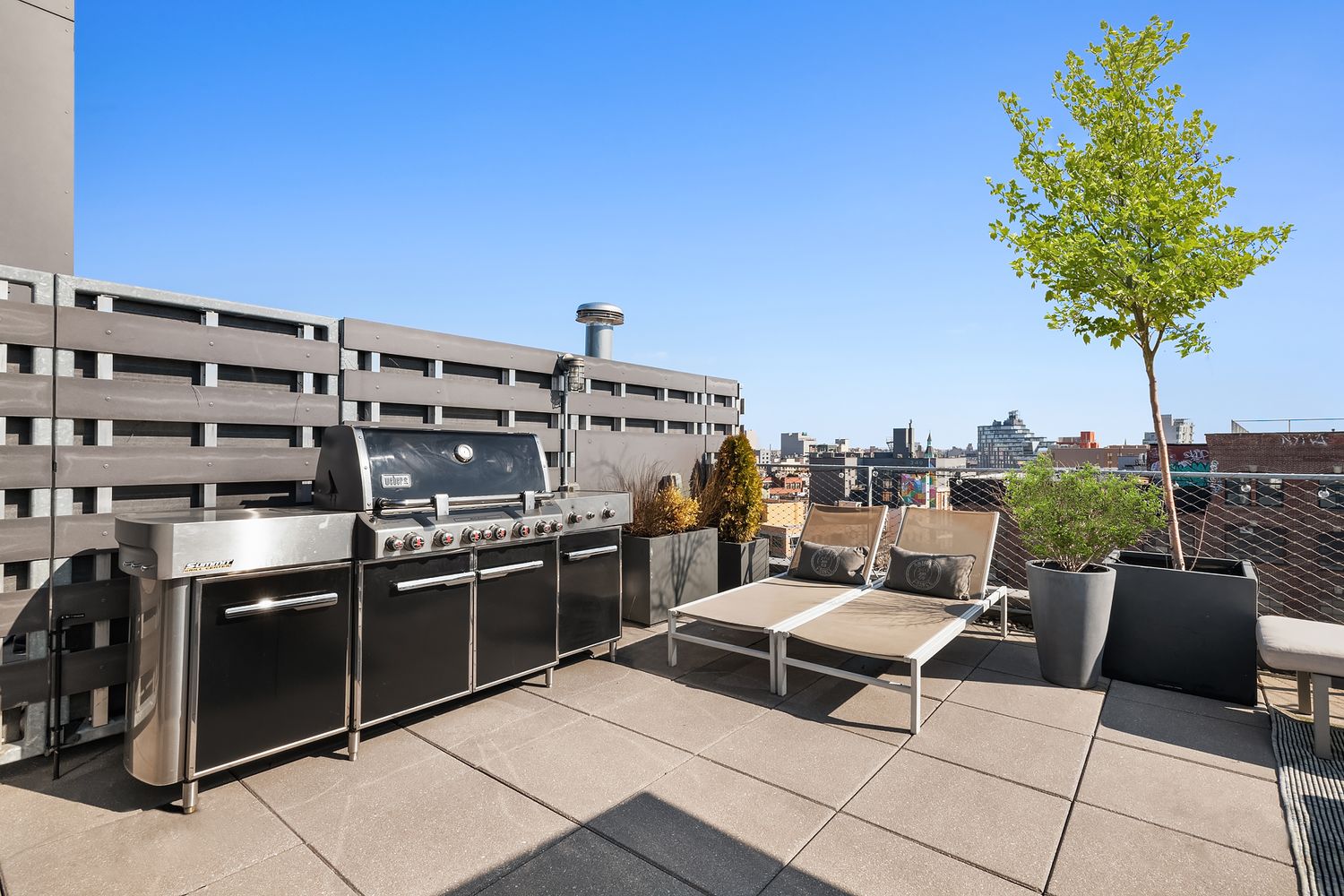 280 Metropolitan Avenue, Unit 5D Brooklyn, NY 11211 - Photo 18 of 22 a terrace with outdoor seating and city view
