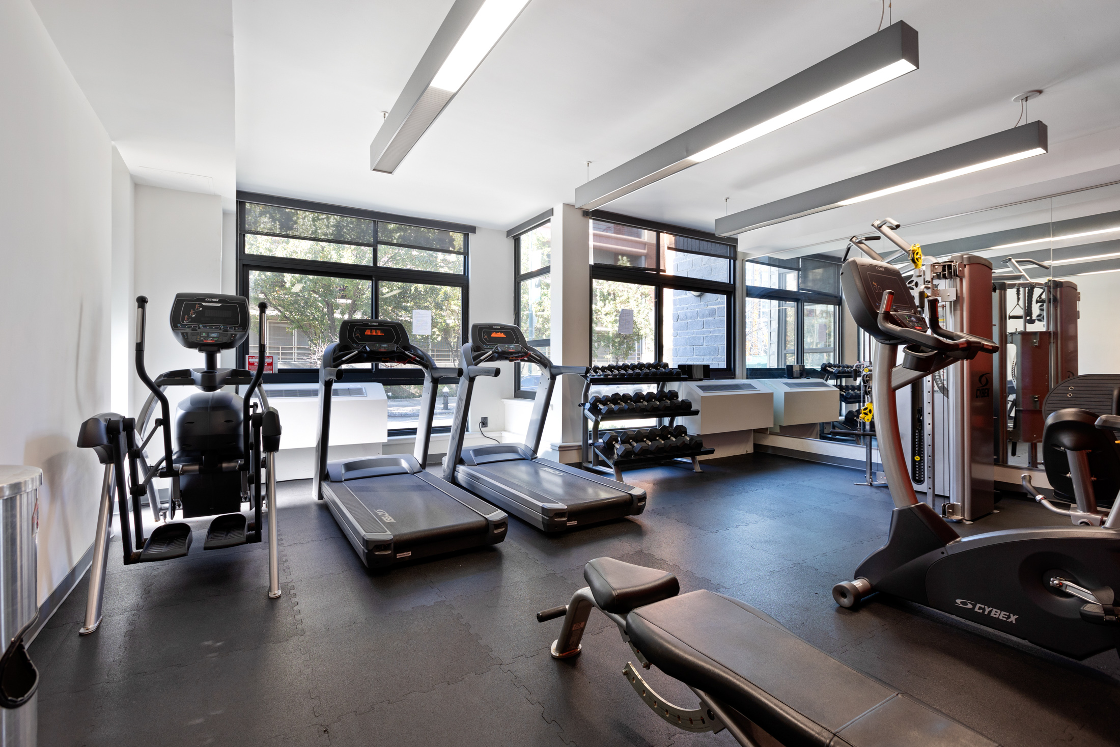 48-21 5th Street, Unit 3H Queens, NY 11101 - Photo 7 of 10 a living room with furniture gym equipment and a large window