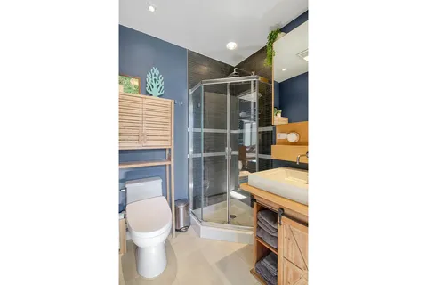 a bathroom with a toilet sink and a shower