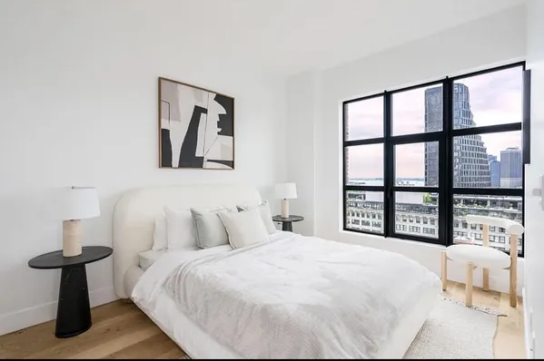 a bedroom with a large bed and a window