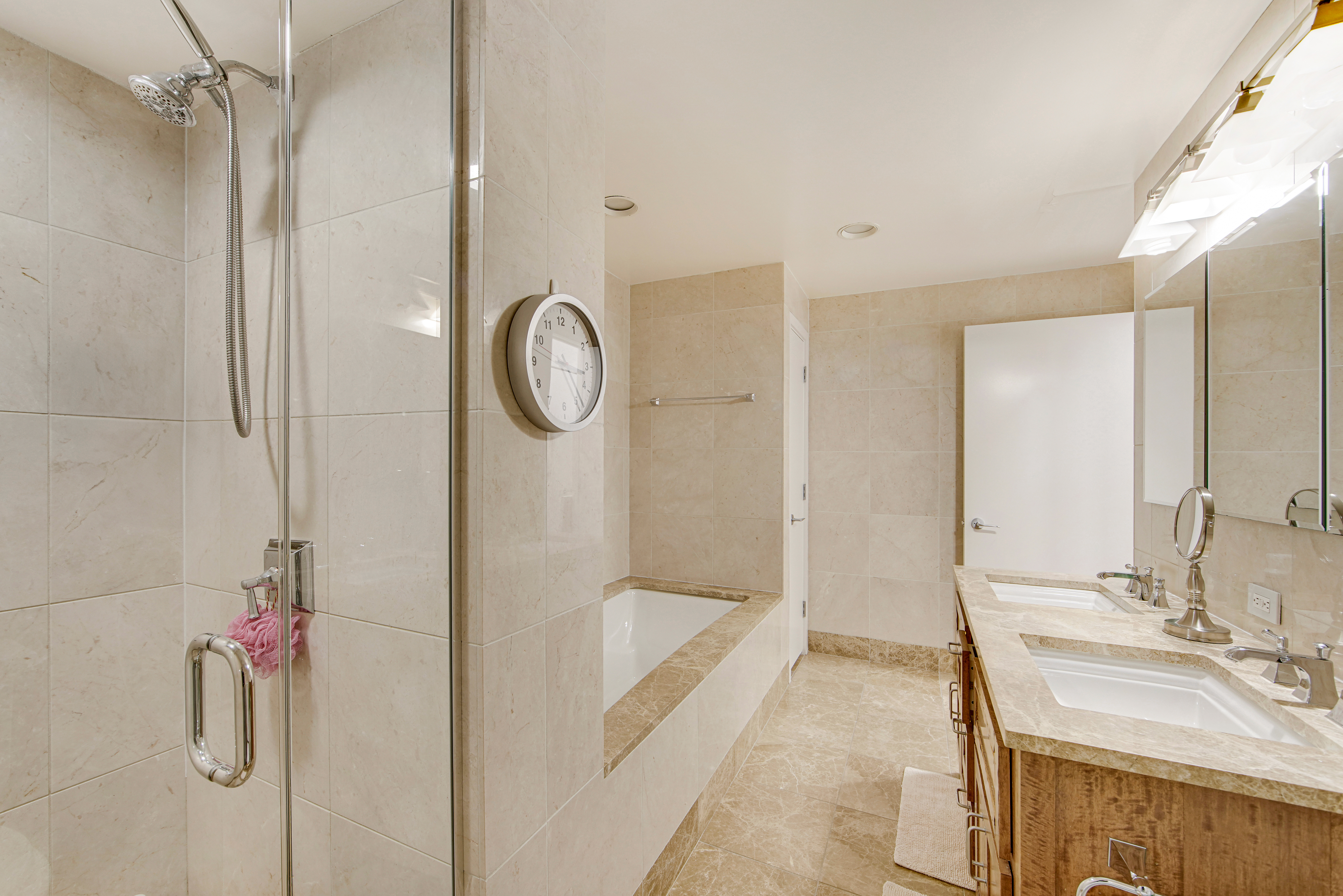 45 Park Avenue, Unit 202 Manhattan, NY 10016 - Photo 10 of 17 a bathroom with a granite countertop sink a mirror and shower