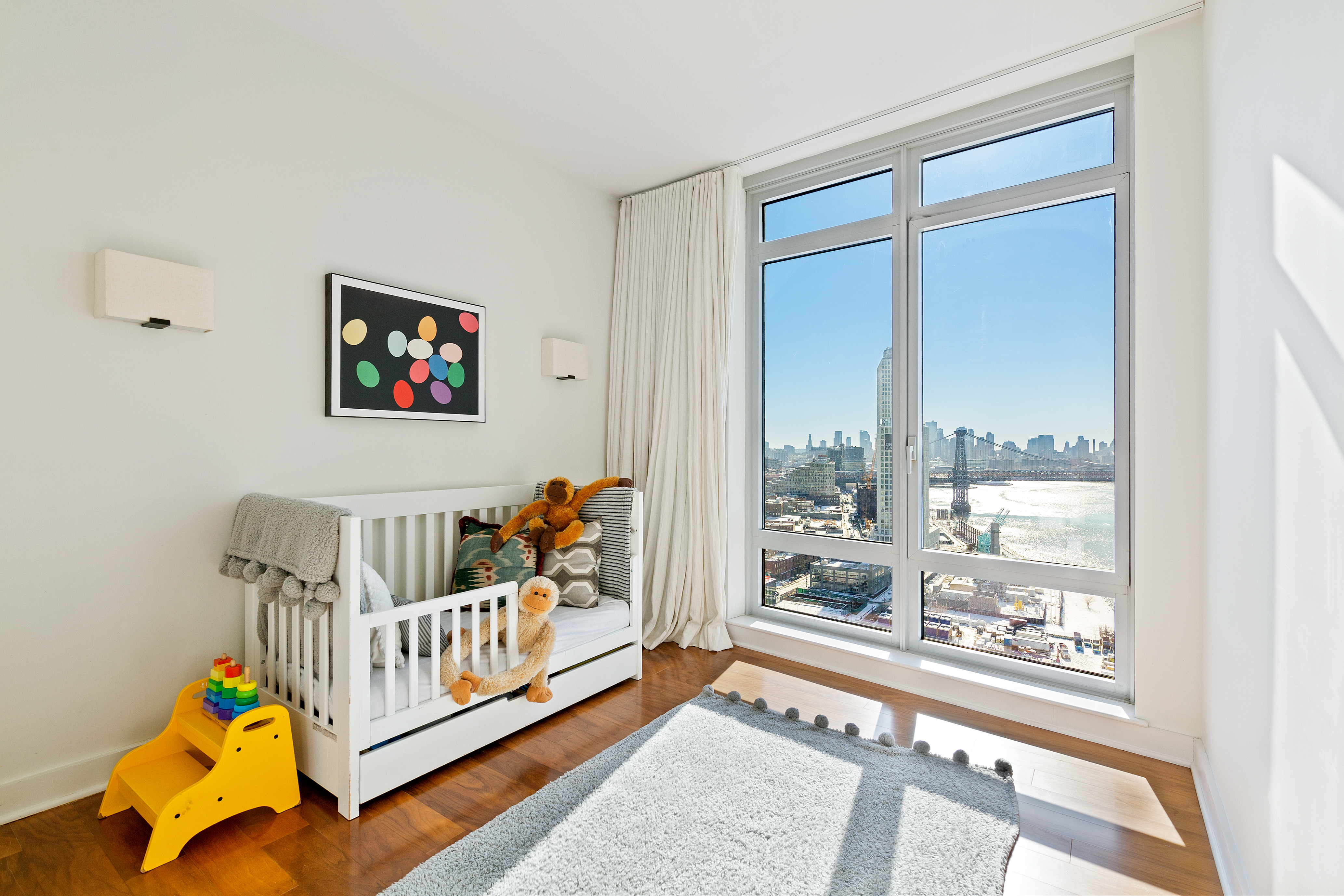 2 Northside Piers, Unit 17A Brooklyn, NY 11249 - Photo 11 of 21 a bedroom with furniture and a large window