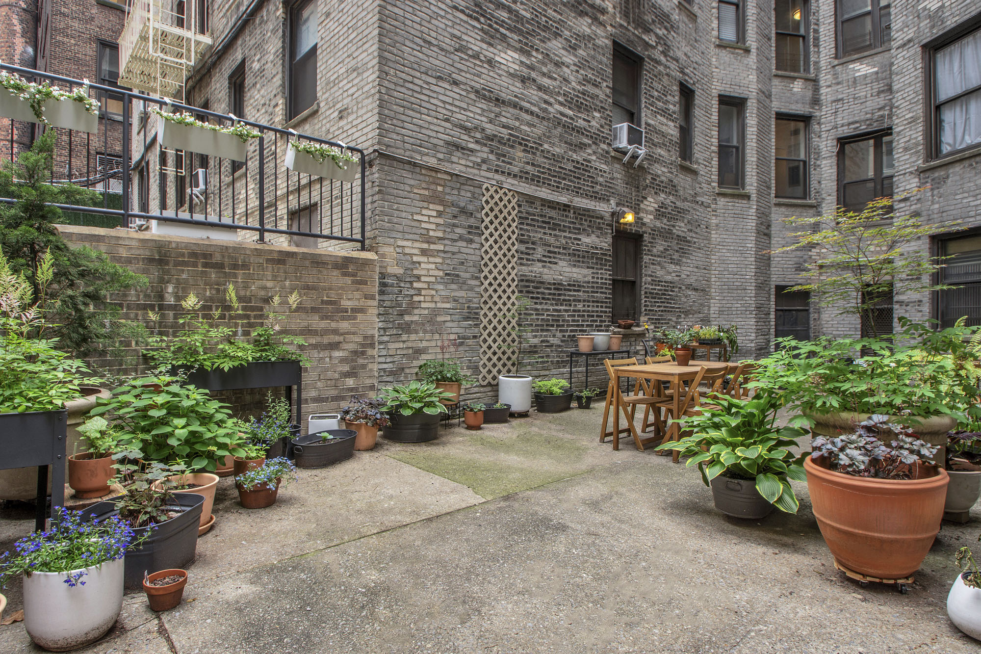 225 West 25th Street, Unit 5K Manhattan, NY 10001 - Photo 13 of 17 a view of a backyard with sitting area and potted plants