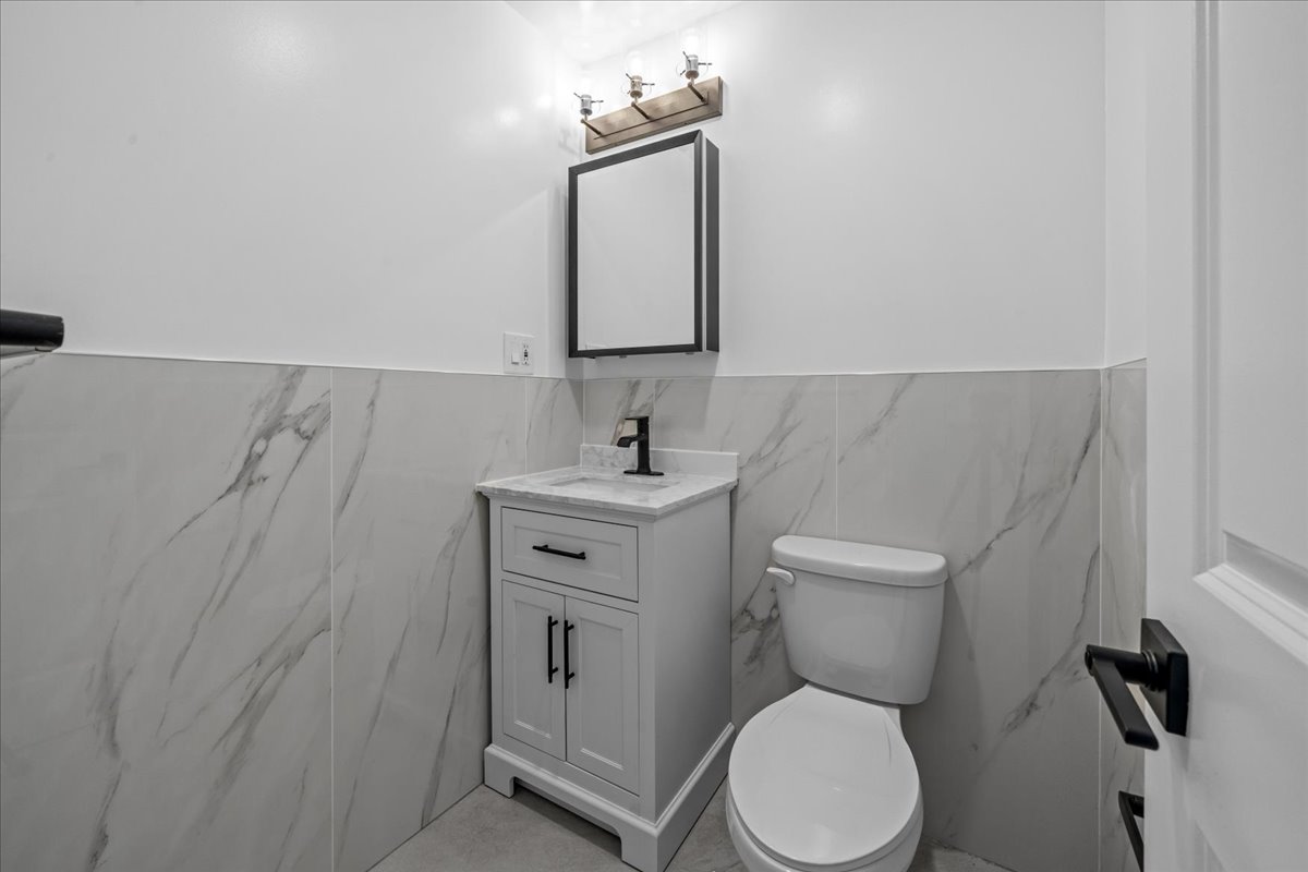 81 Suydam Street, Unit MULTI Brooklyn, NY 11221 - Photo 13 of 18 a bathroom with a toilet sink and mirror