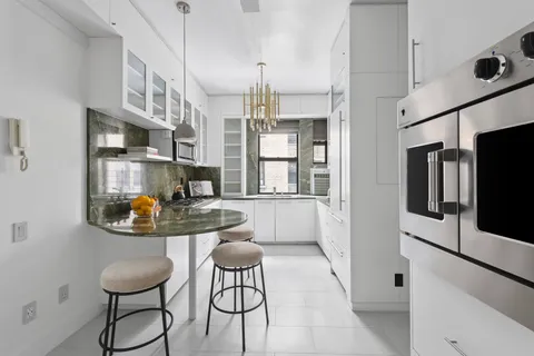 a kitchen with stainless steel appliances granite countertop a sink and a refrigerator