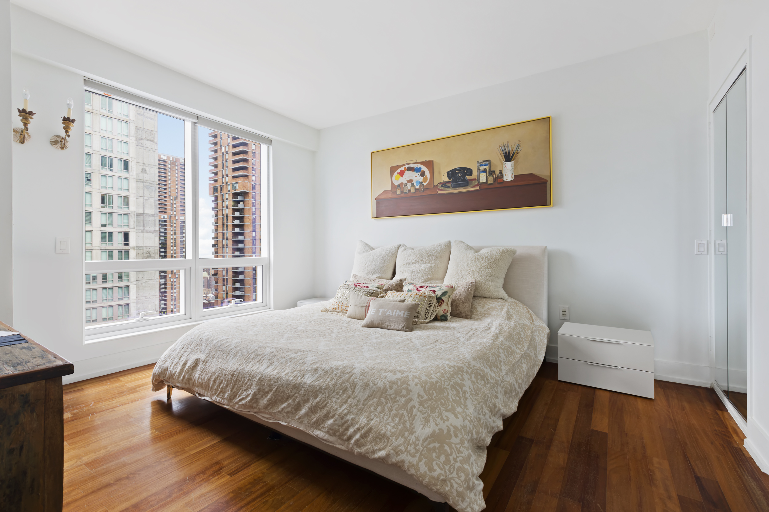 350 West 42nd Street, Unit 20L Manhattan, NY 10036 - Photo 7 of 11 a bedroom with a bed and a large window