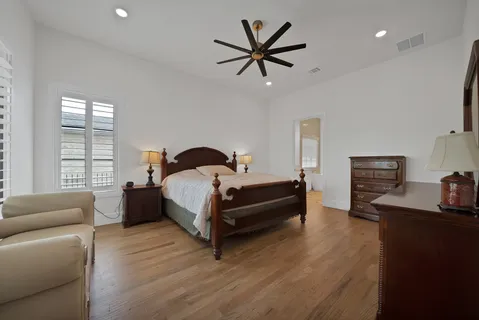 a bedroom with a bed a couch and a window
