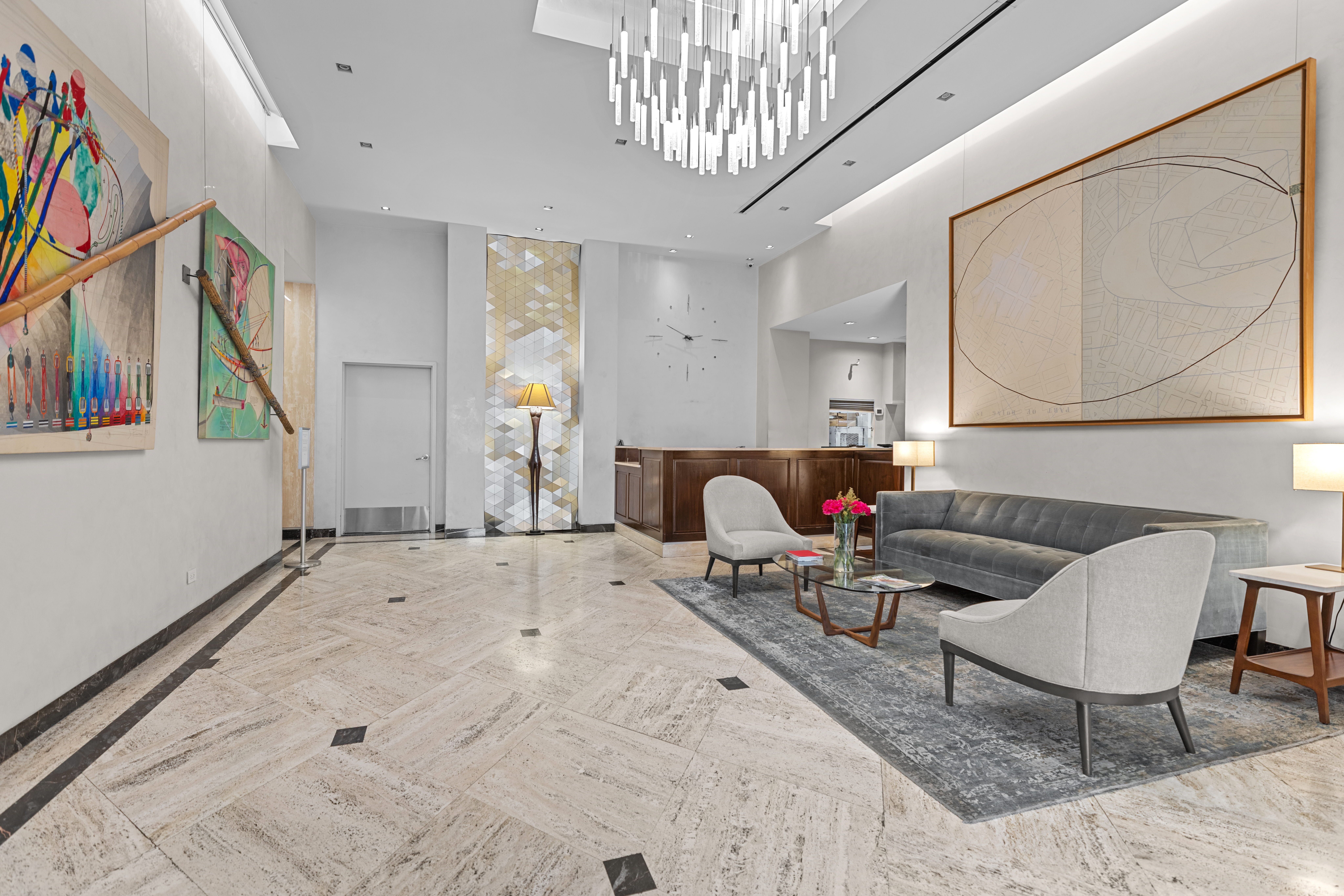 159 West 53rd Street, Unit 31F Manhattan, NY 10019 - Photo 10 of 16 a living room with furniture and a chandelier