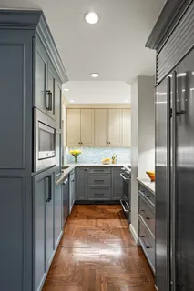 a large kitchen with a refrigerator and a stove