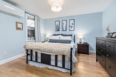a bedroom with a bed and a dresser