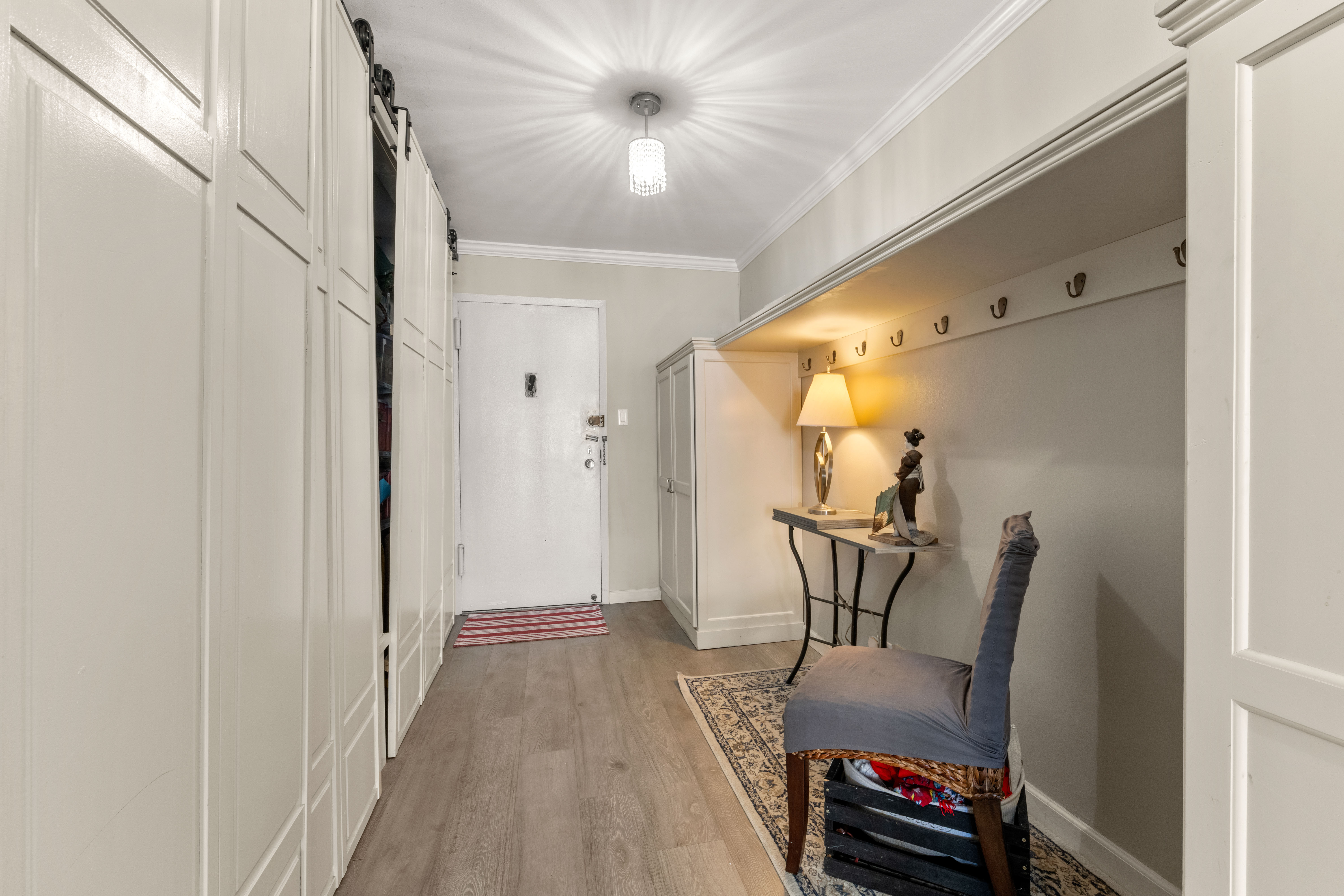 102-30 66th Road, Unit 7E Queens, NY 11375 - Photo 8 of 15 a view of a hallway with furniture and wooden floor