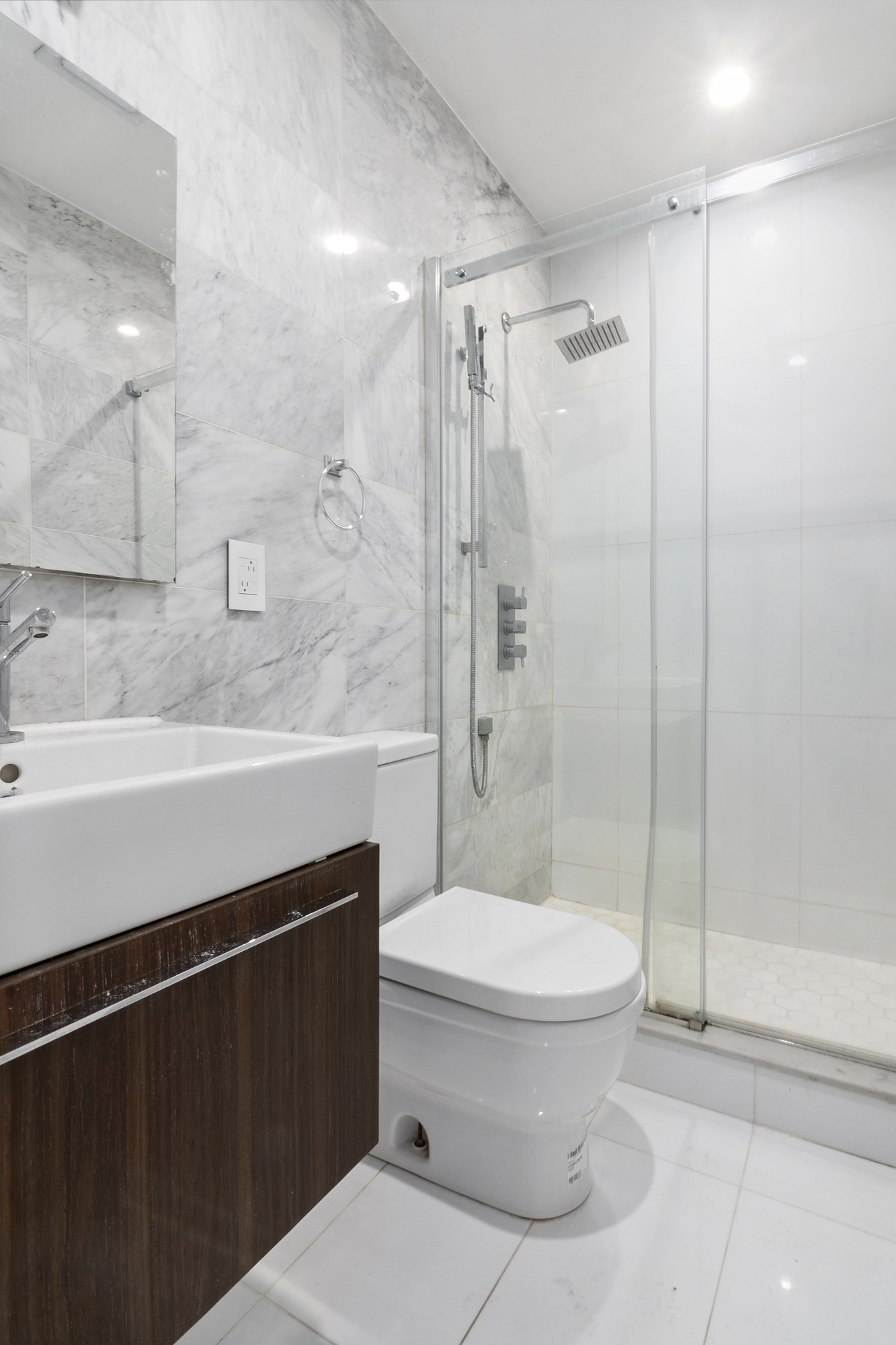 211 8th Avenue, Unit 3B Brooklyn, NY 11215 - Photo 8 of 13 a bathroom with a toilet a sink and shower