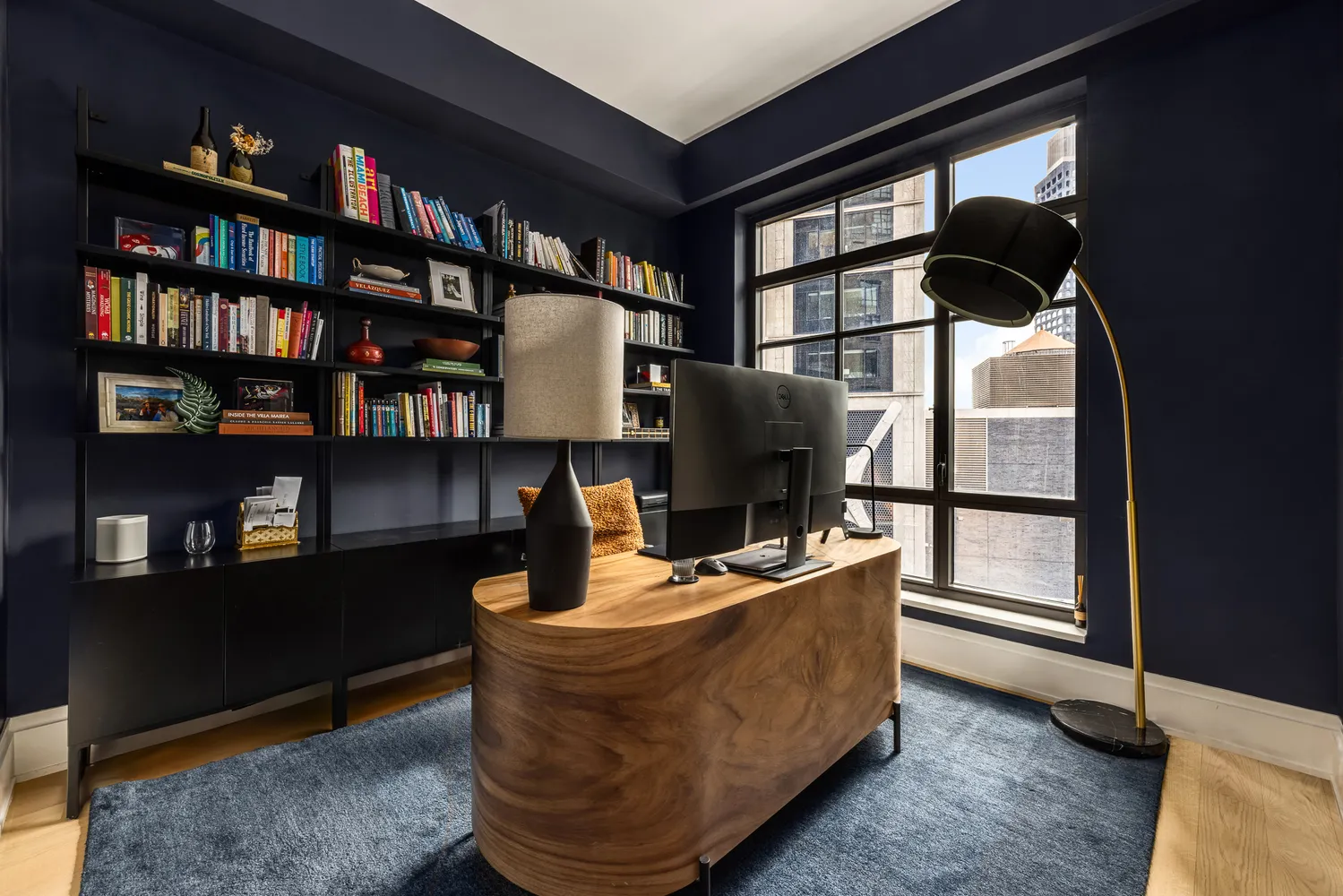 a living room with furniture and a book shelf