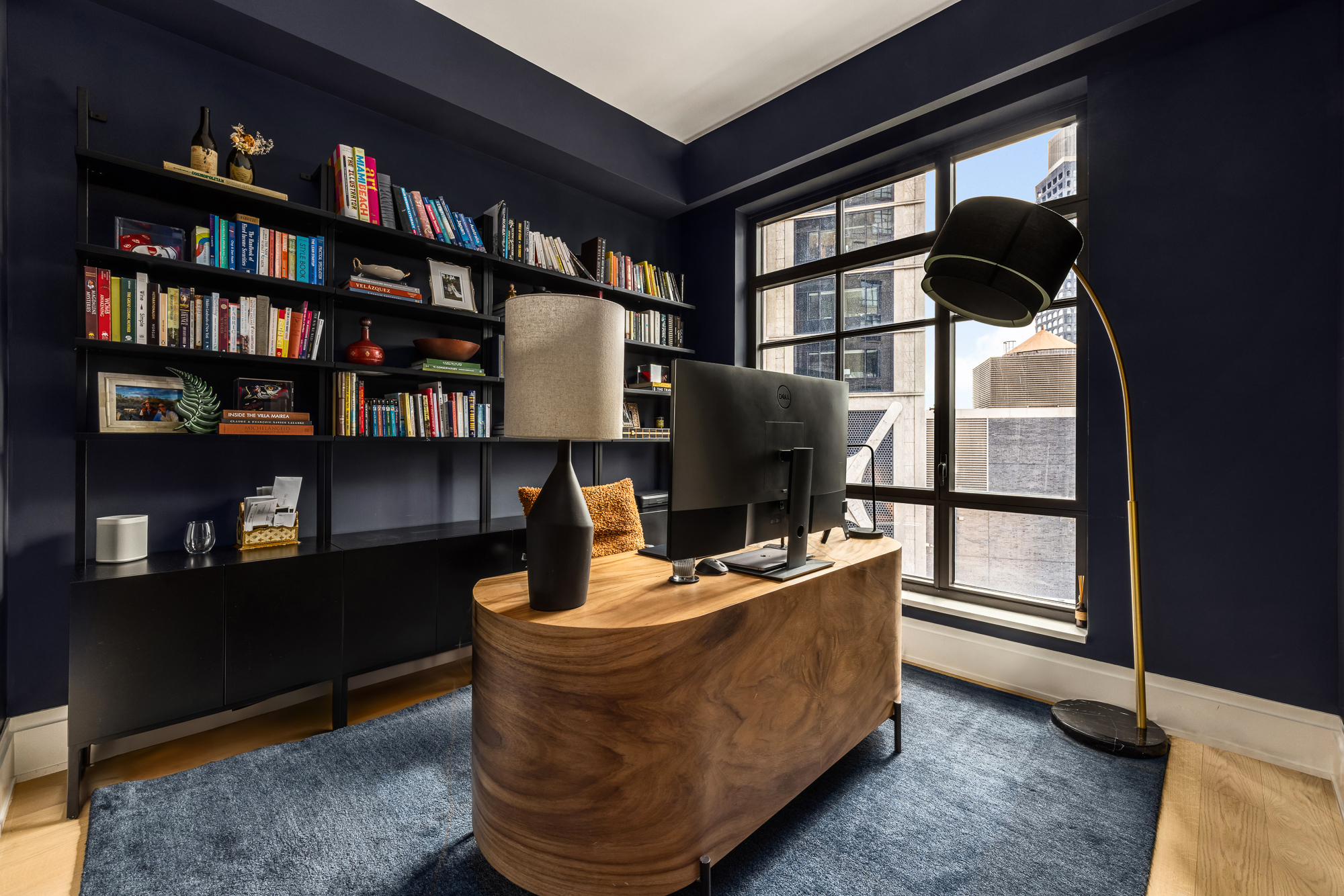 25 Park Row, Unit 29A Manhattan, NY 10038 - Photo 15 of 23 a living room with furniture and a book shelf