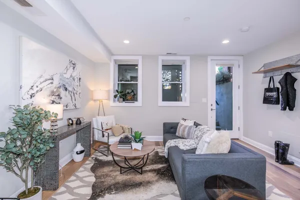 a living room with furniture and a potted plant
