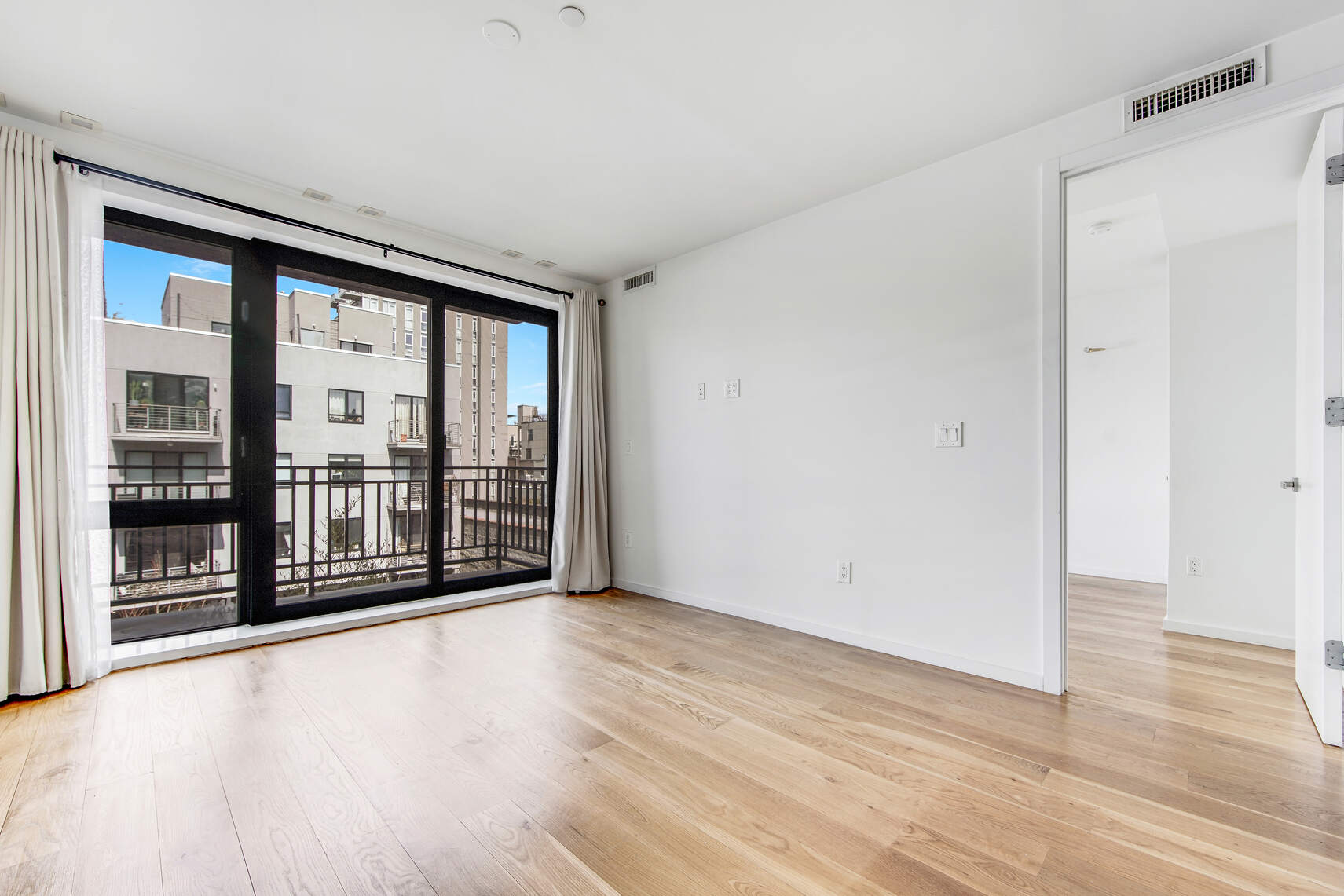 511 Lafayette Avenue, Unit 3B Brooklyn, NY 11205 - Photo 2 of 14 wooden floor in an empty room with a window