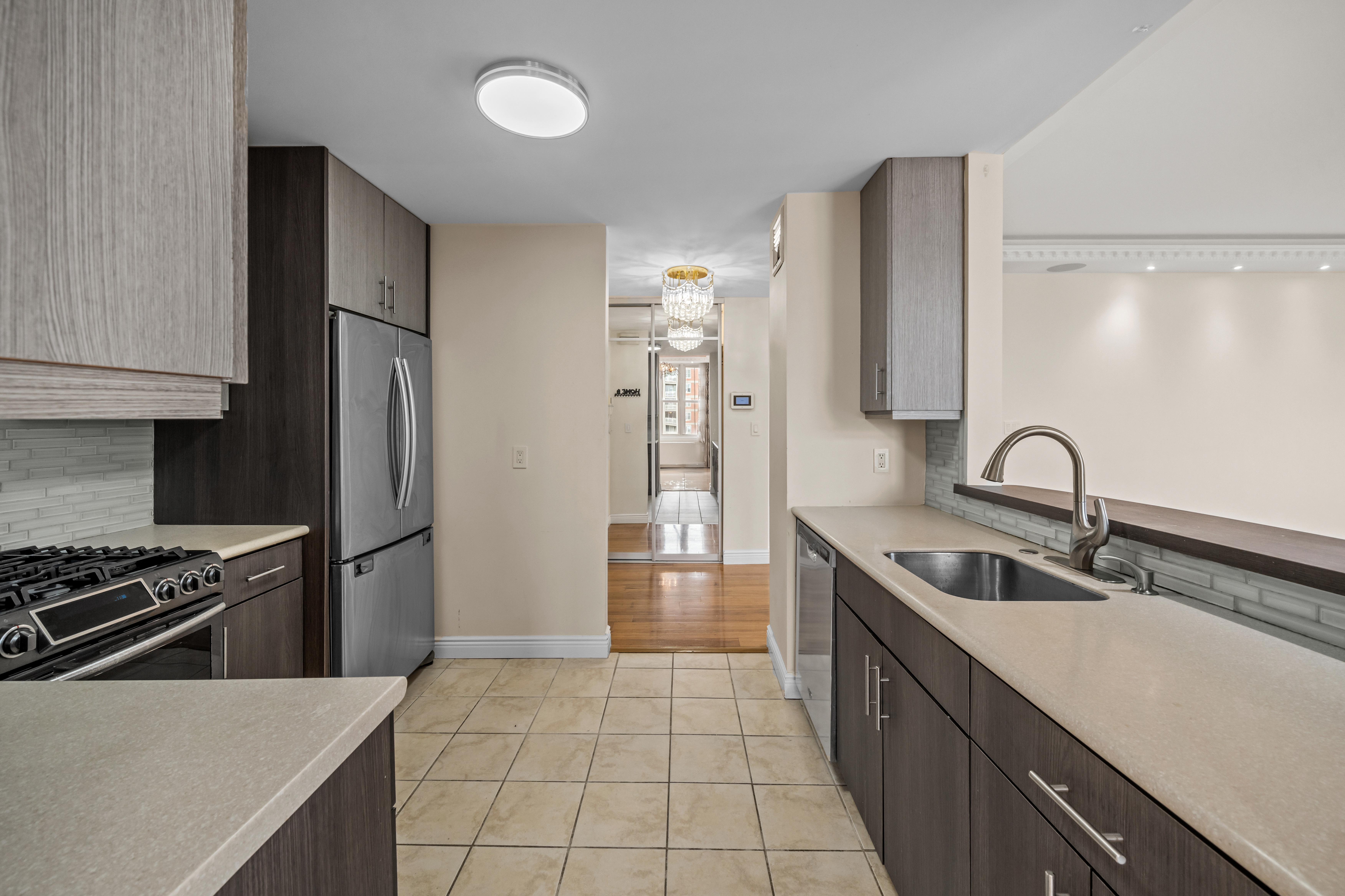 105 Oceana Drive East, Unit PH1D Brooklyn, NY 11235 - Photo 7 of 27 a kitchen with stainless steel appliances granite countertop a sink stove and refrigerator