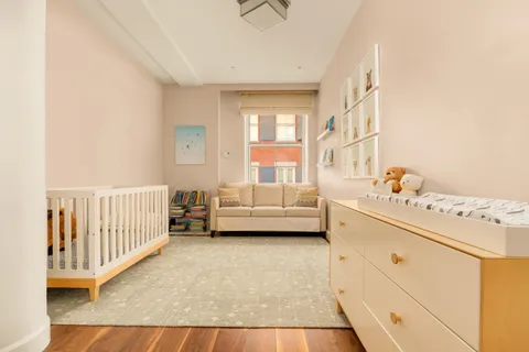 a view of a bedroom with furniture and window