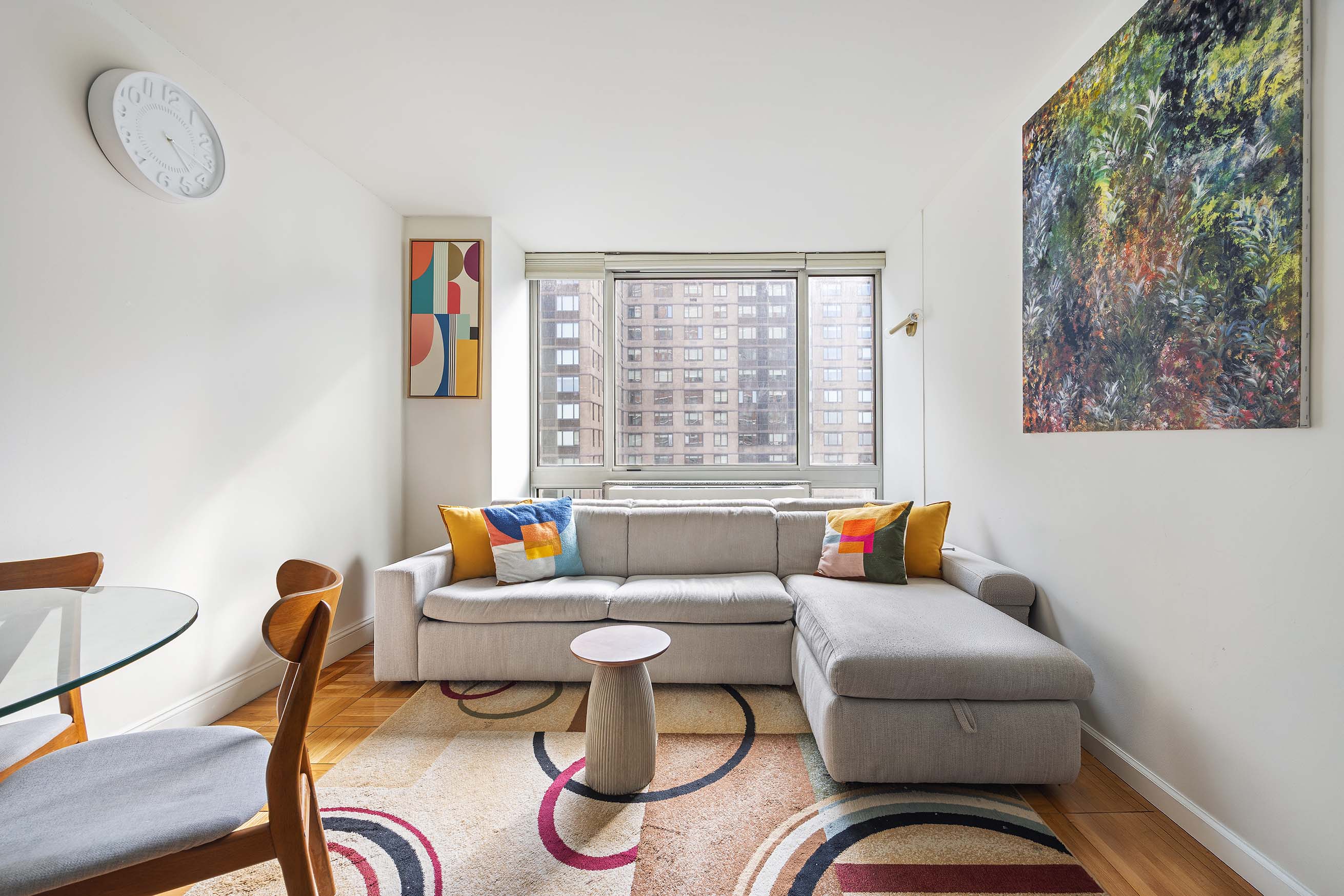 215-217 East 96th Street, Unit 26F Manhattan, NY 10128 - Photo 2 of 19 a living room with furniture and a window