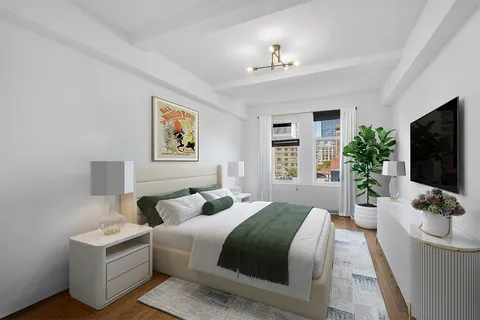 a bedroom with a large bed and a flat screen tv