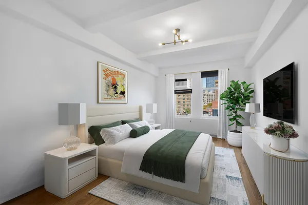 a bedroom with a large bed and a flat screen tv