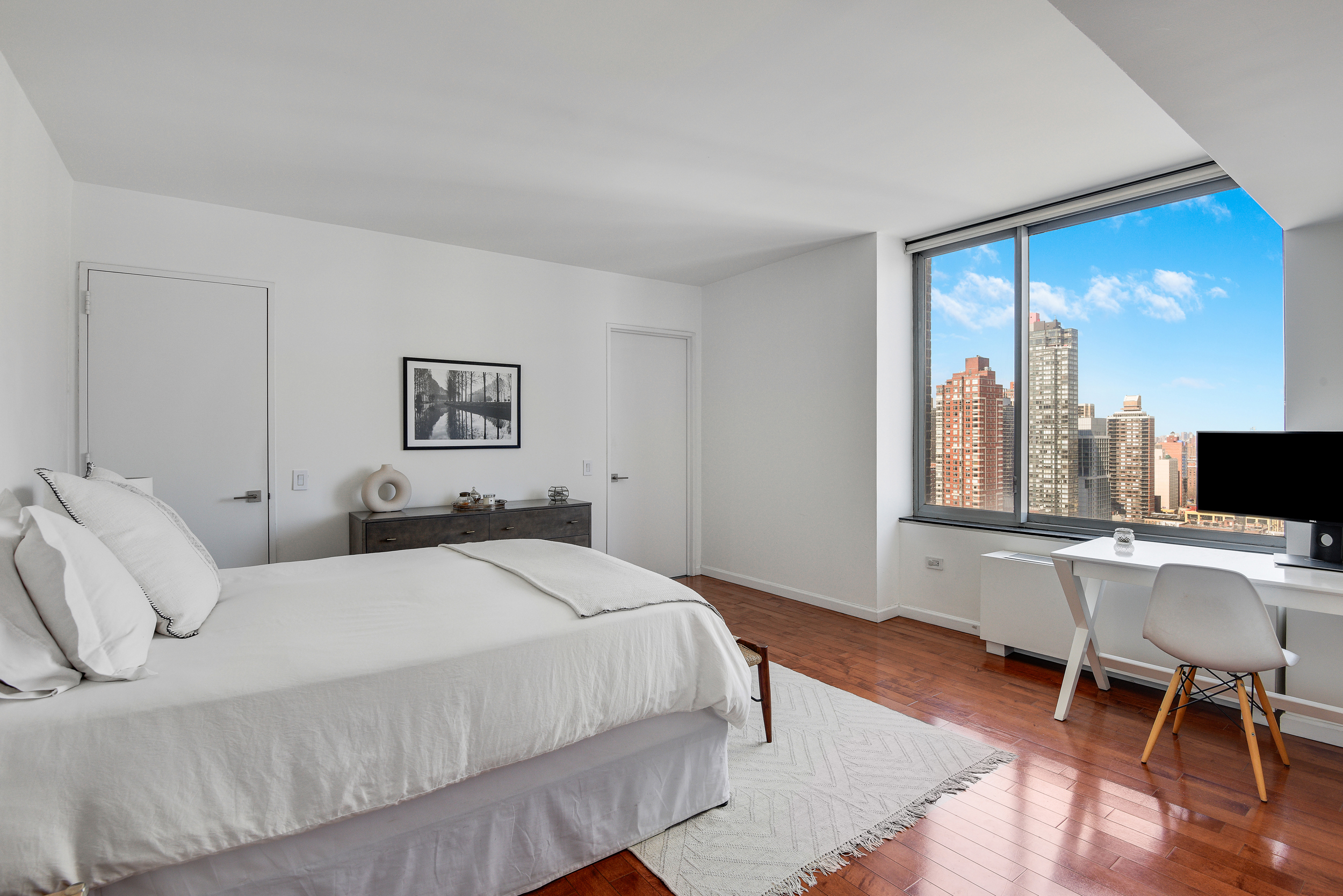 360 East 88th Street, Unit 22C Manhattan, NY 10128 - Photo 11 of 33 a bedroom with a bed and large window