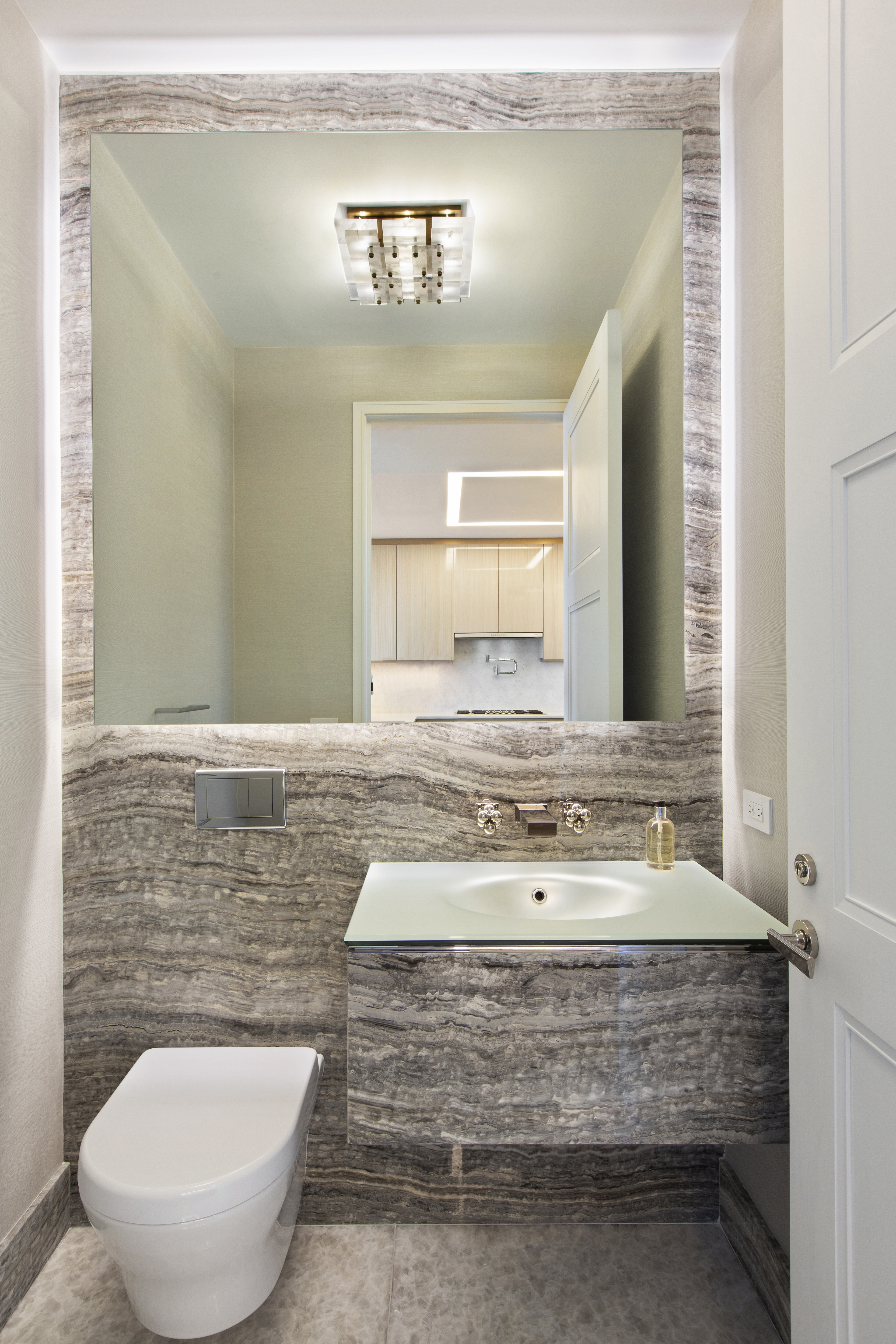 35 Hudson Yards, Unit 5805 Manhattan, NY 10001 - Photo 6 of 16 a bathroom with a toilet sink and mirror
