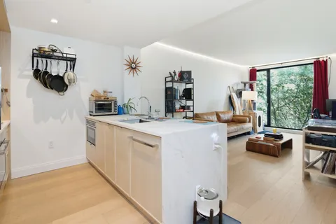 a kitchen view living space with furniture and a flat screen tv